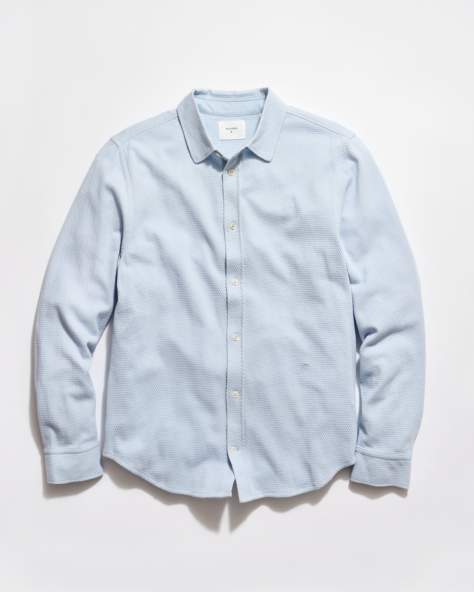 Light blue button-up shirt on a white background