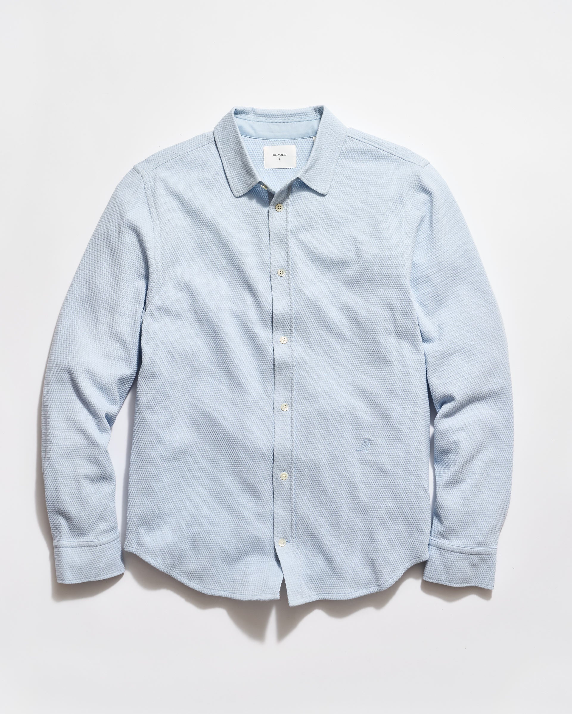 Light blue button-up shirt on a white background