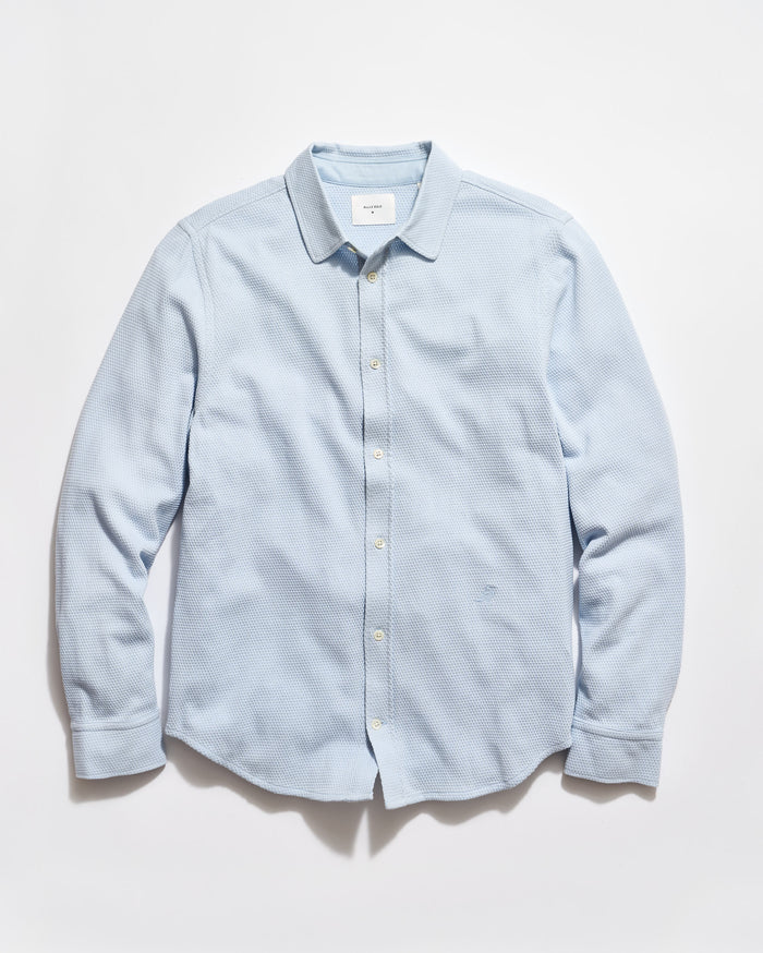Light blue button-up shirt on a white background
