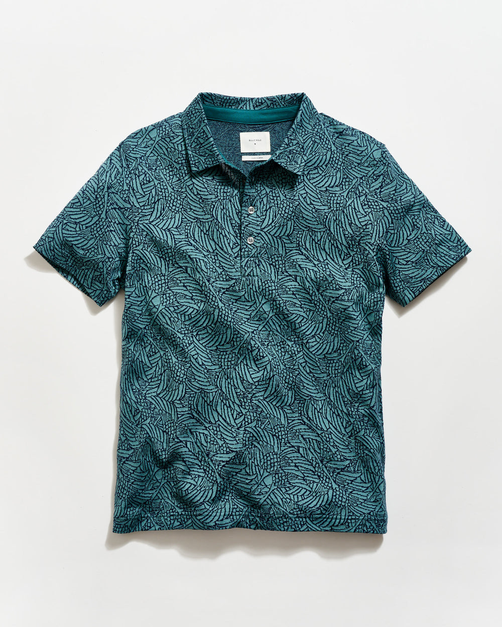 Green patterned polo shirt on a white background