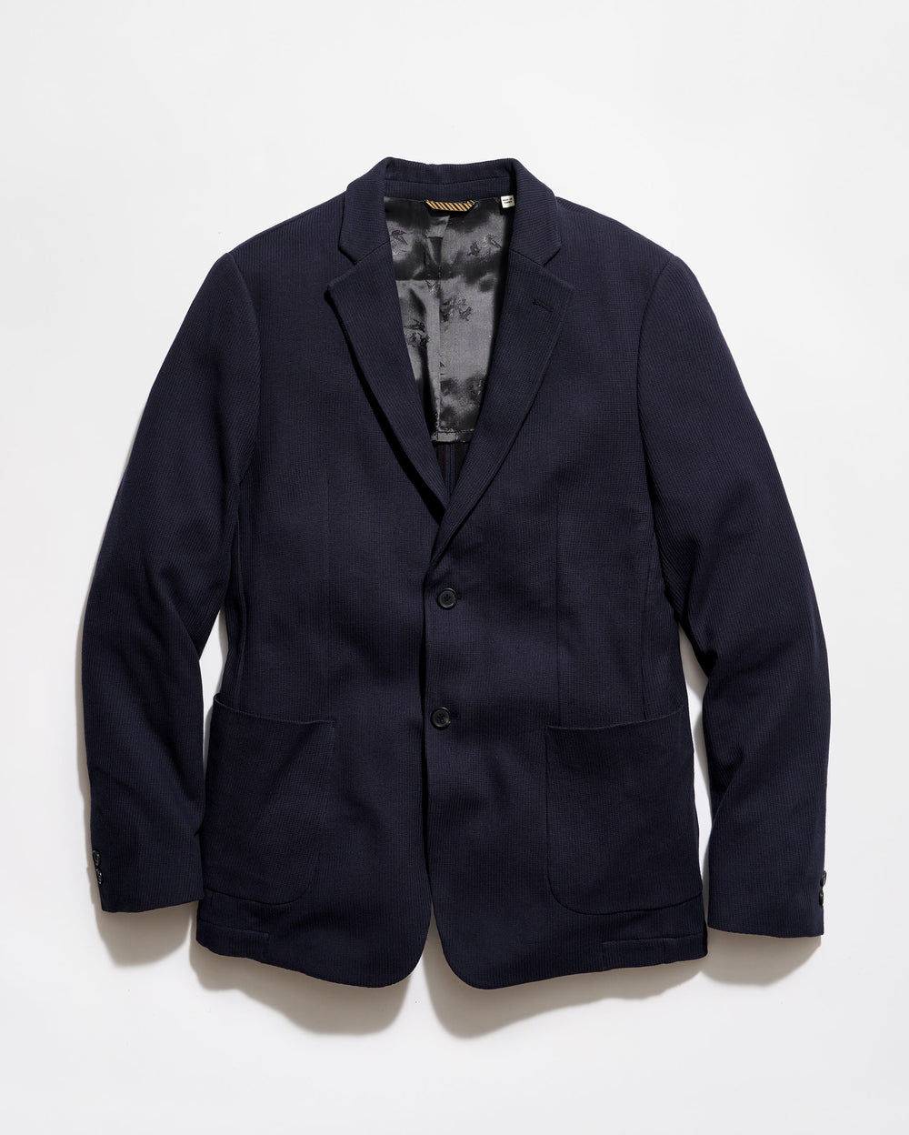 Navy blazer on a light gray background