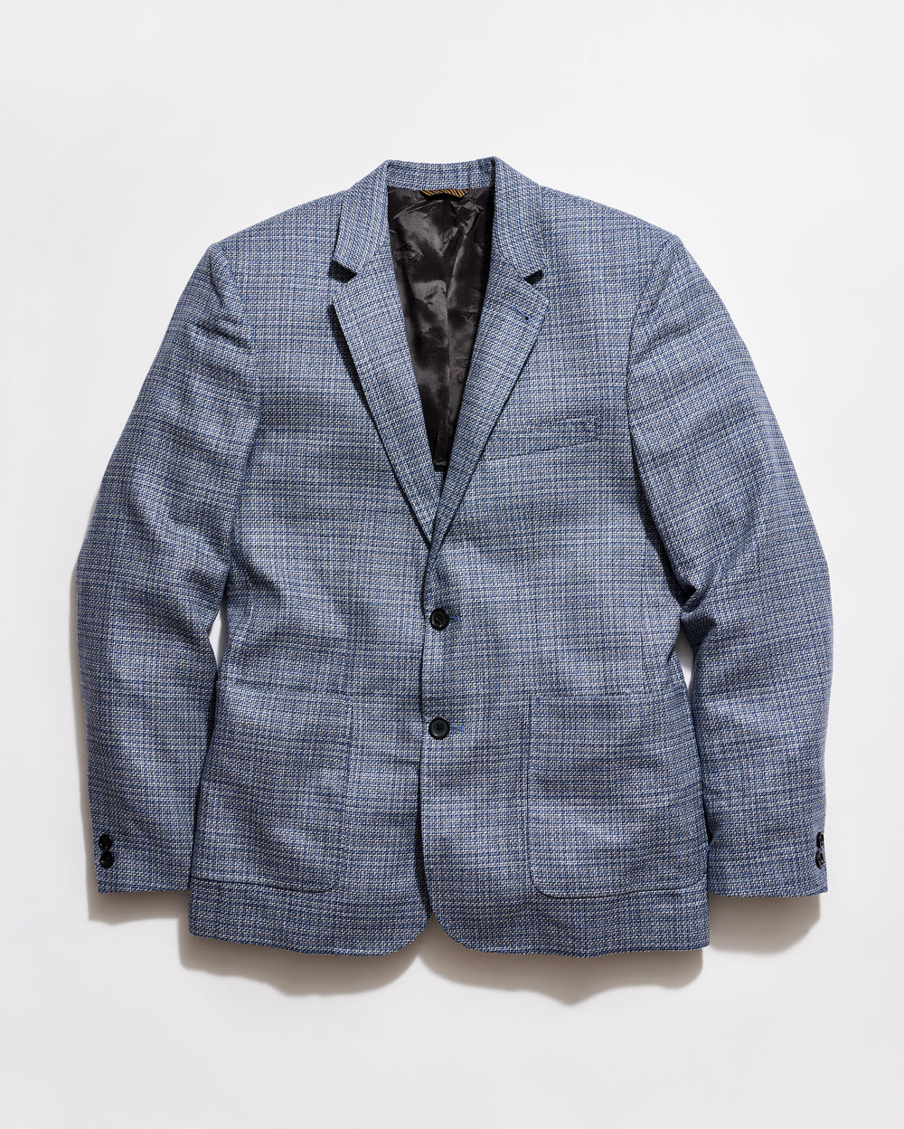 Blue checkered blazer on a light gray background