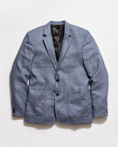 Blue checkered blazer on a light gray background