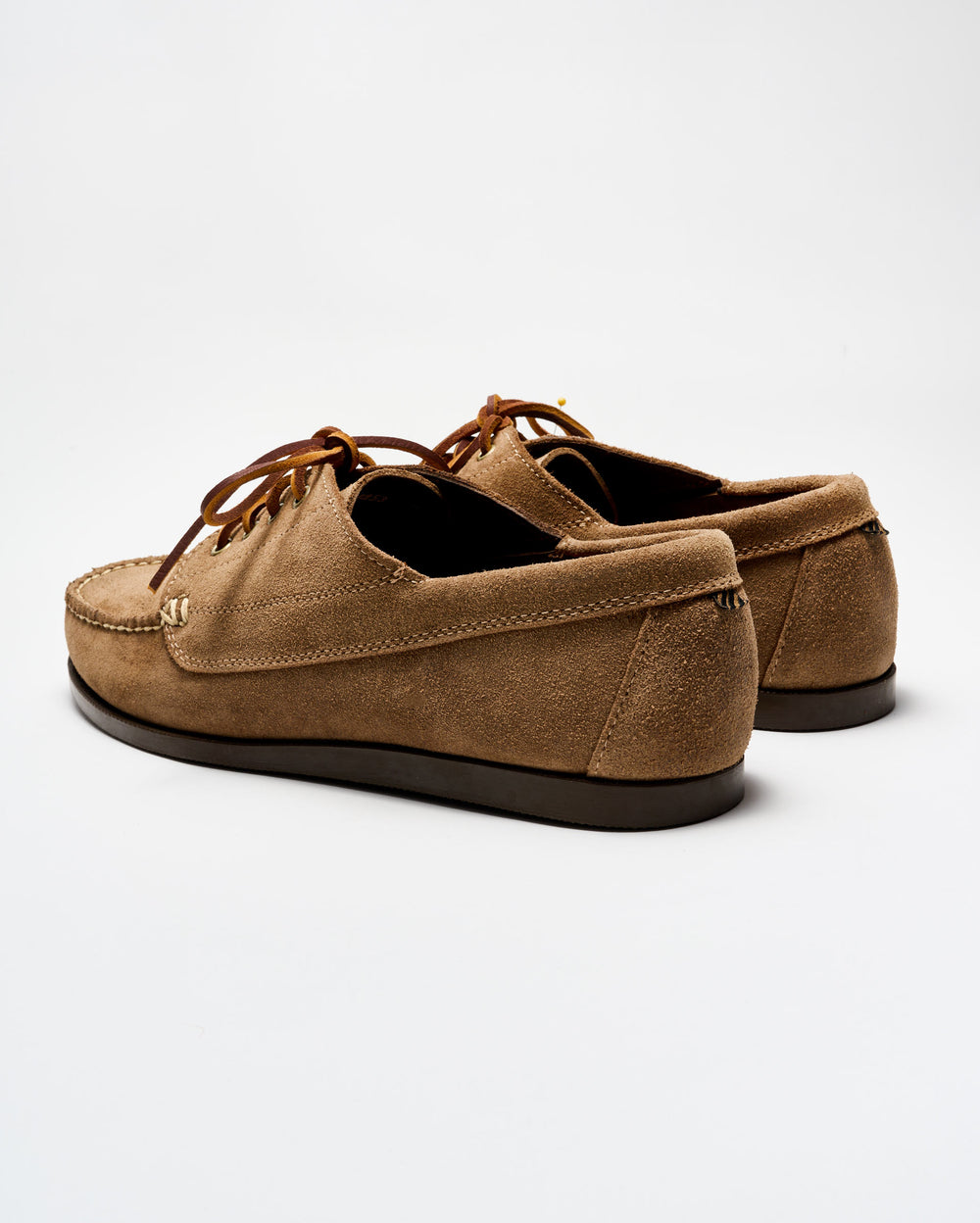 Pair of brown suede shoes on a white background