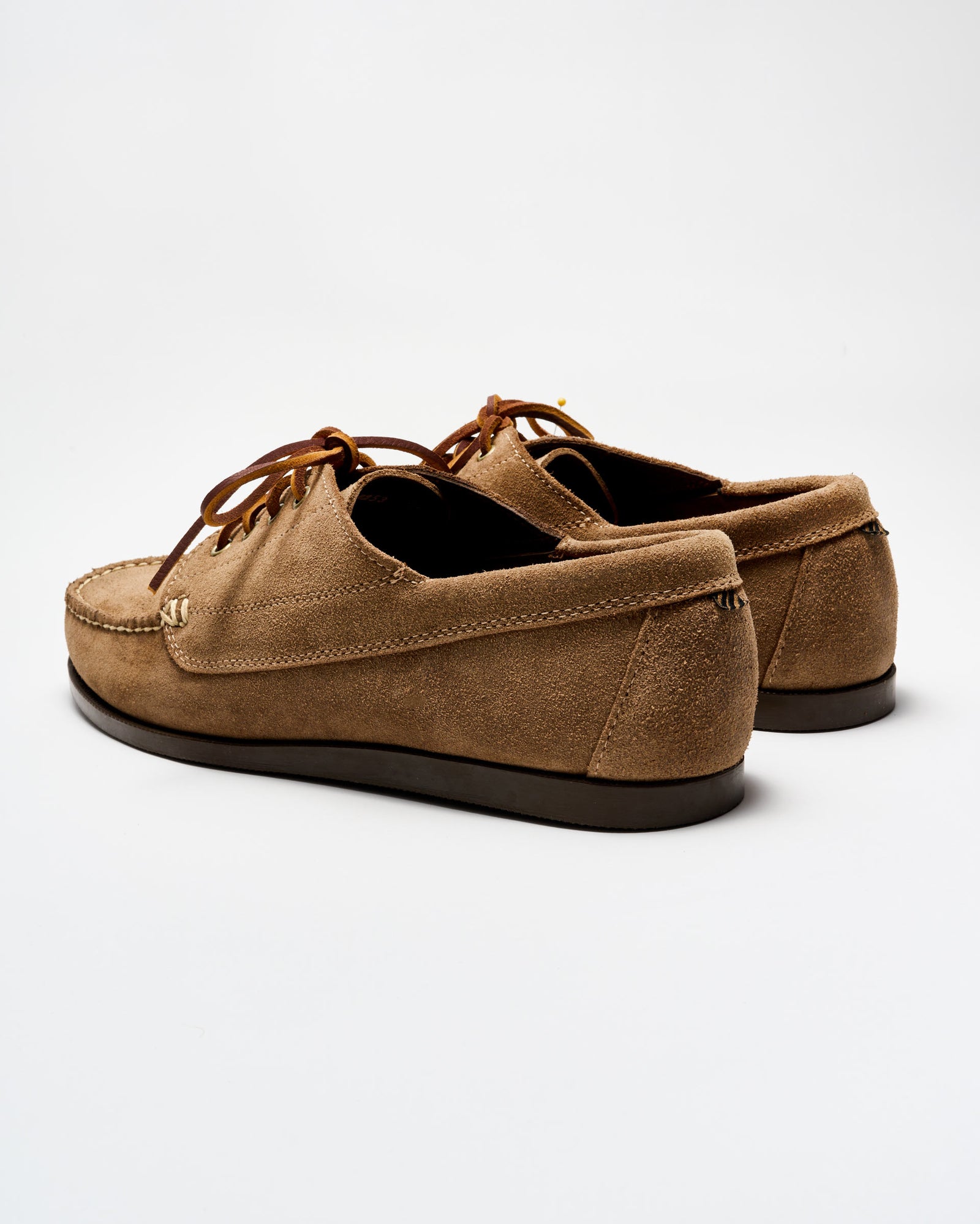 Pair of brown suede shoes on a white background