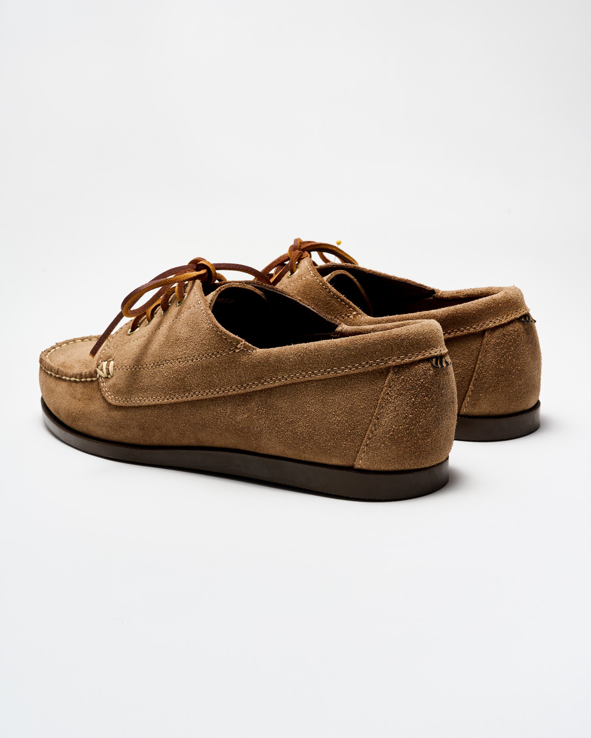 Pair of brown suede shoes on a white background