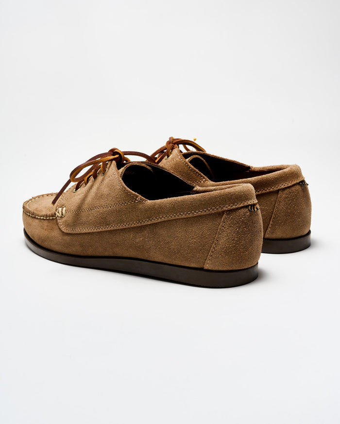 Pair of brown suede shoes on a white background