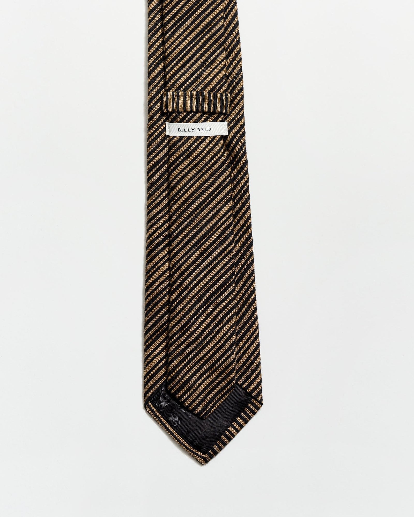 Striped tie with a brand label on a white background