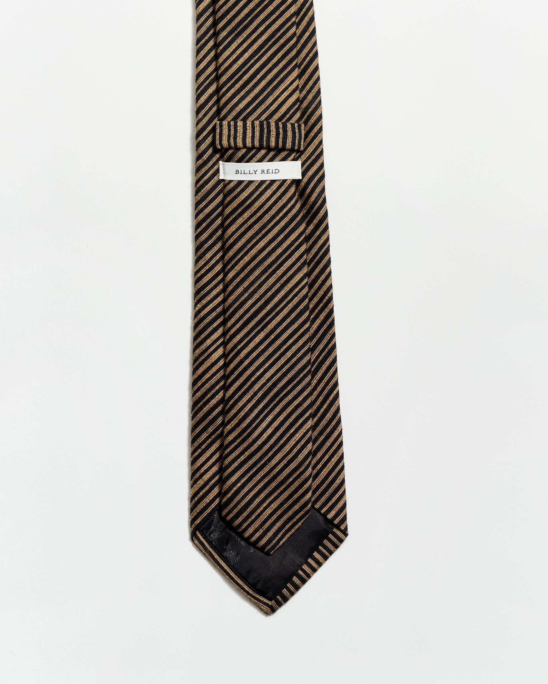 Striped tie with a brand label on a white background