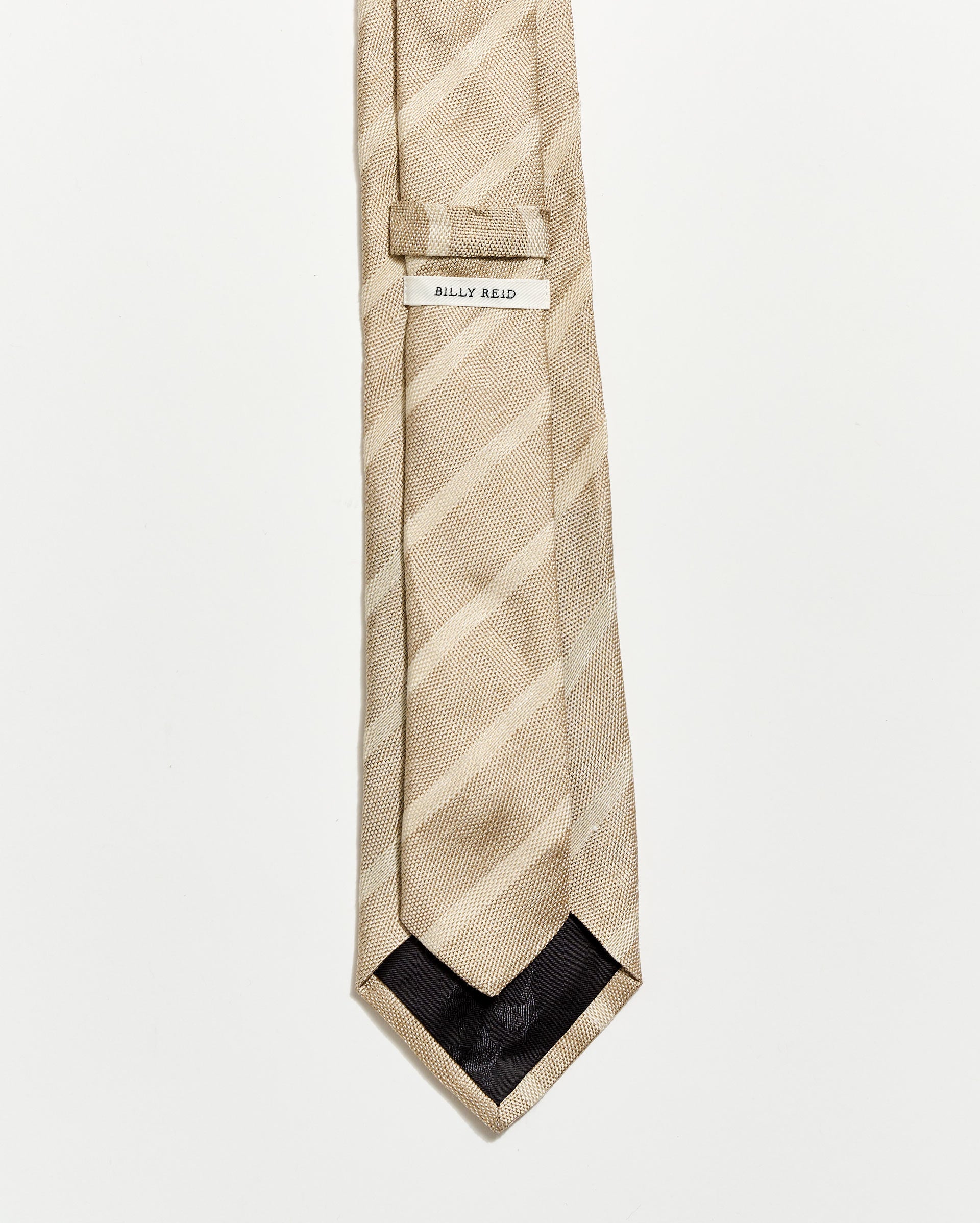 Beige striped tie with a brand label on a white background