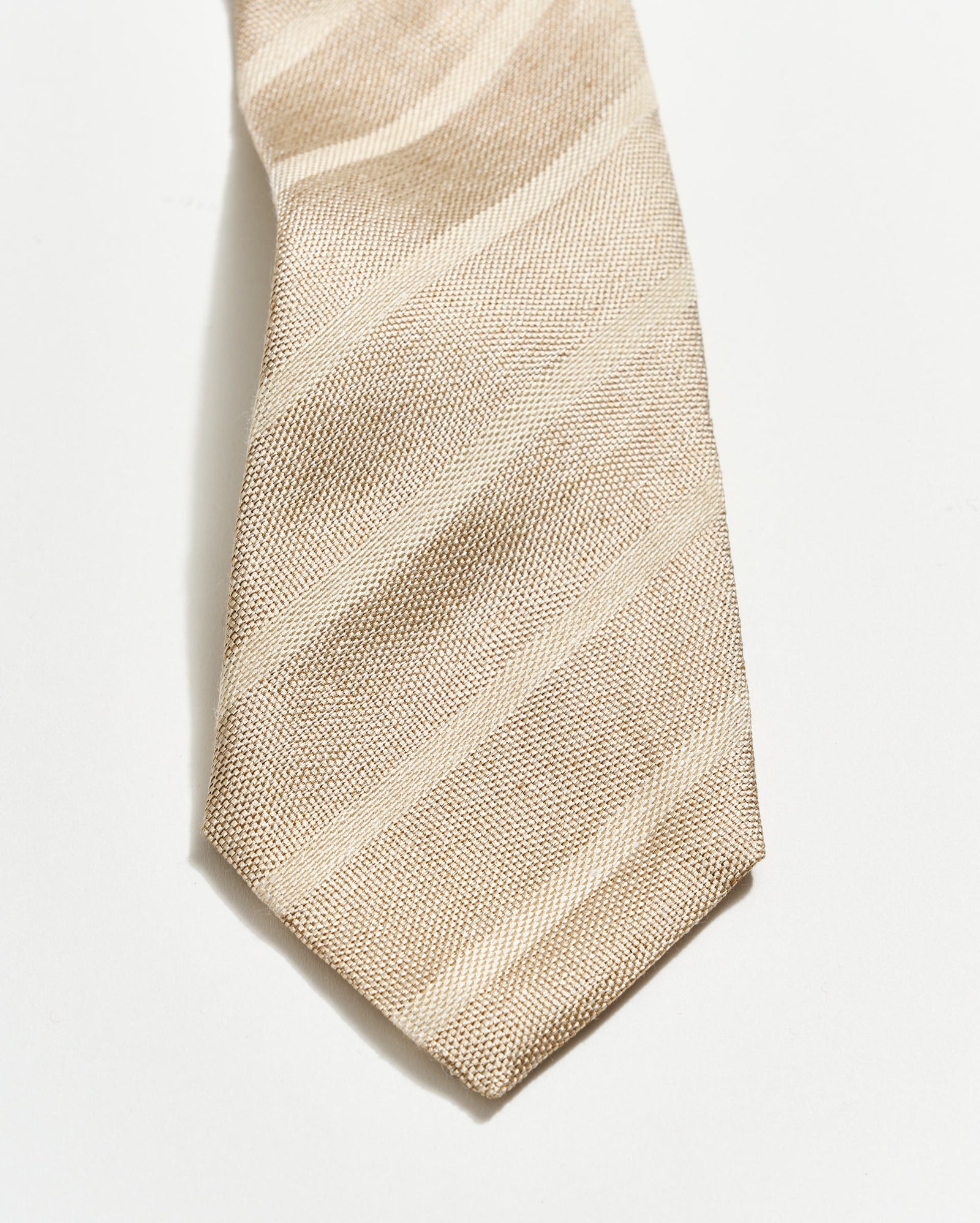 Beige textured tie on a white background