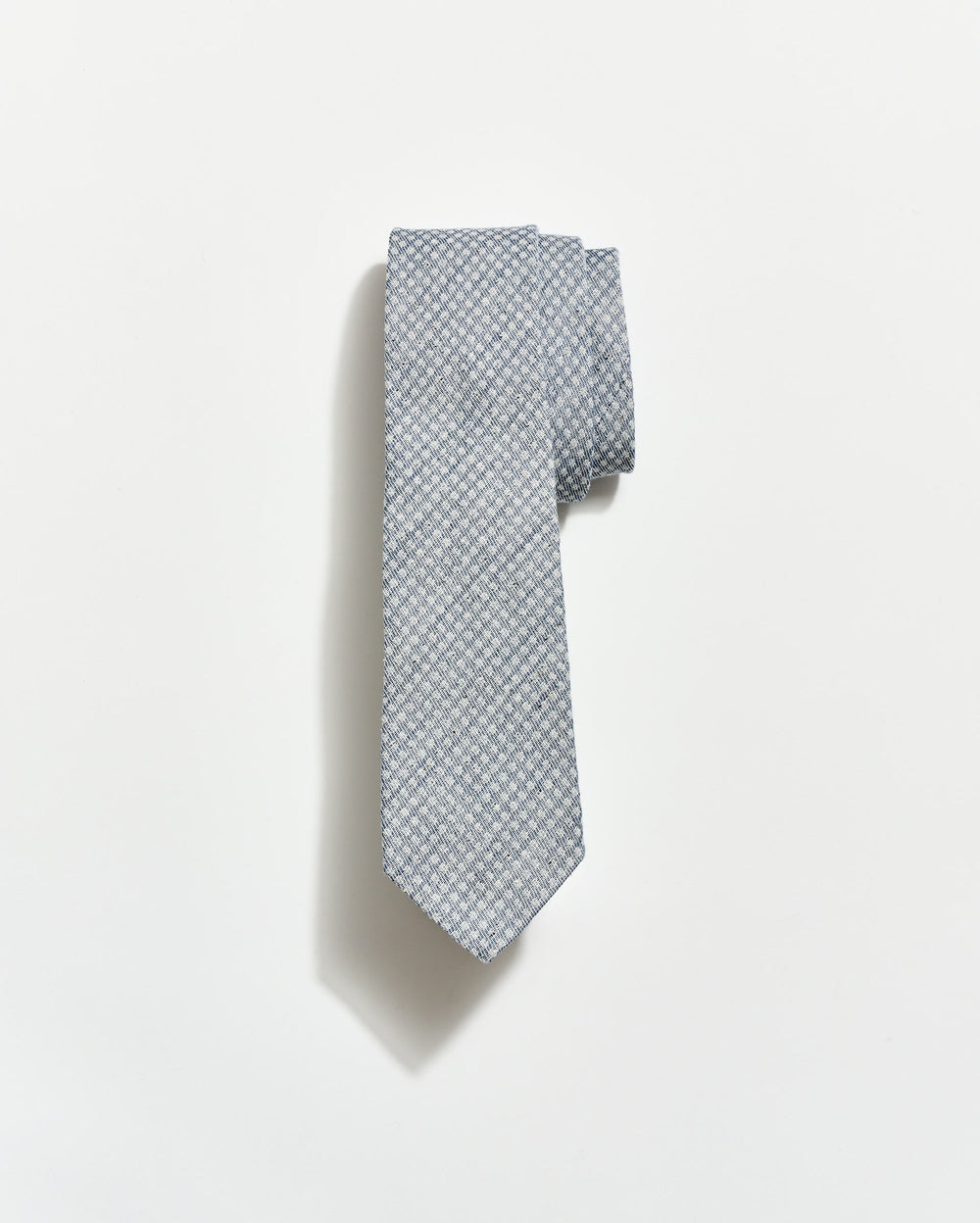 Gray patterned tie on a white background