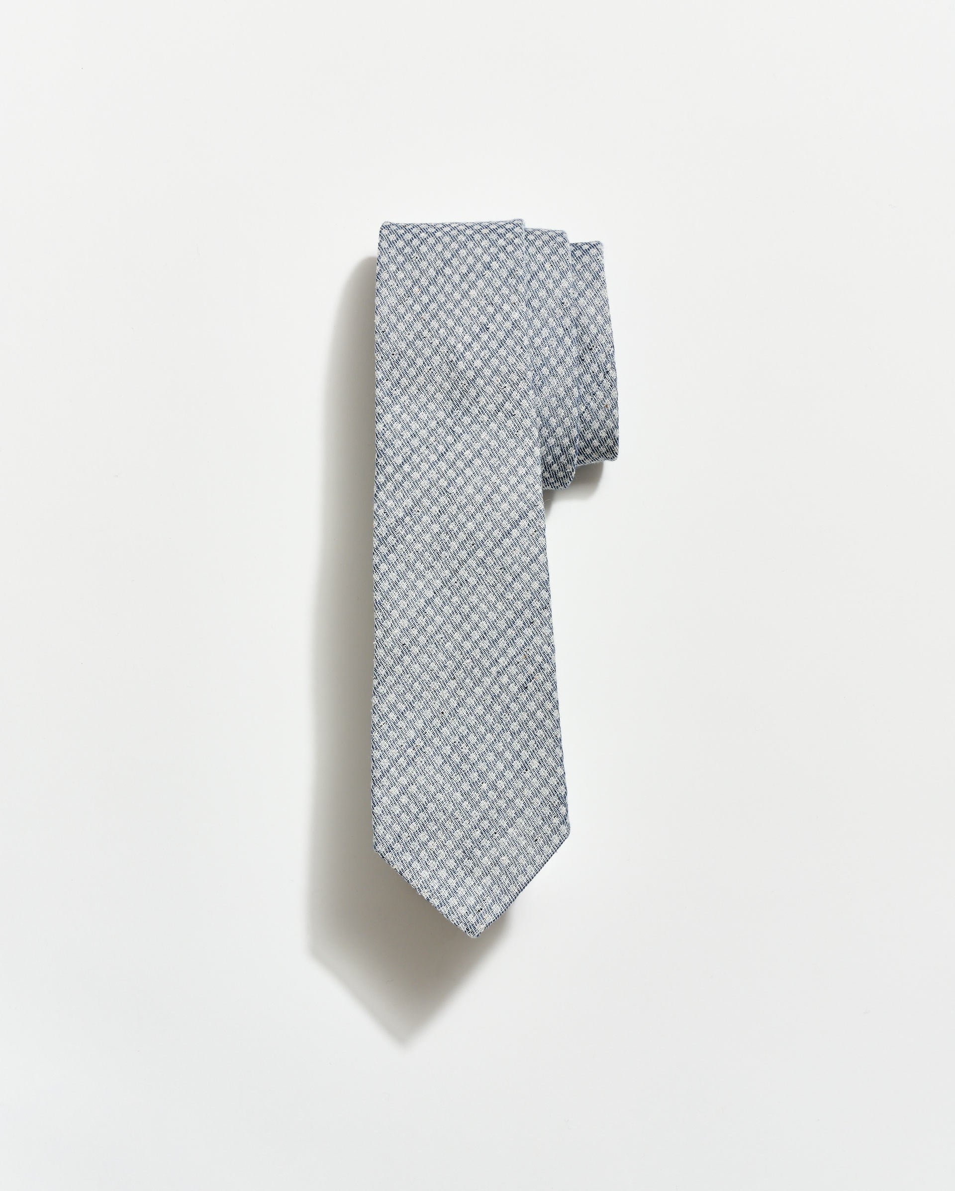 Gray patterned tie on a white background