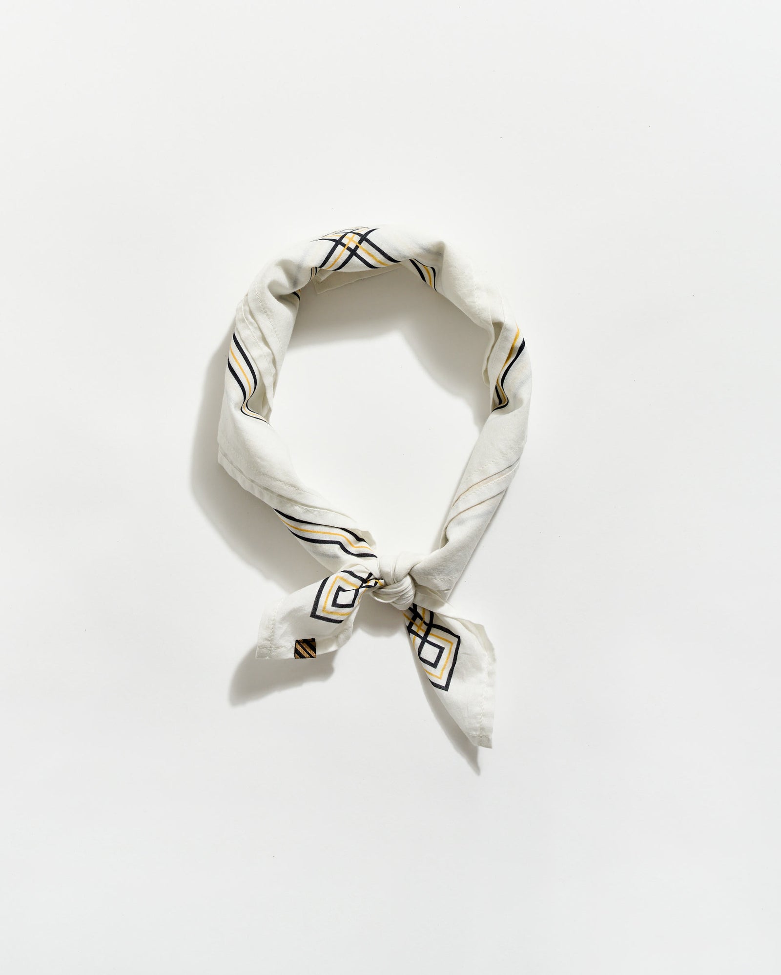 White bandana with black geometric patterns on a white background