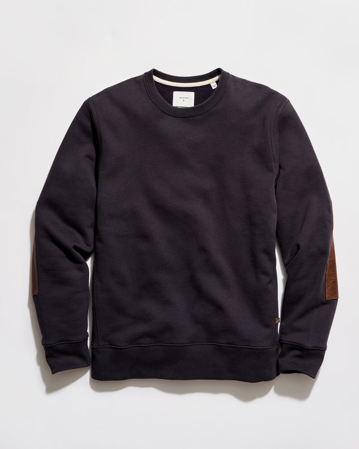 Black sweatshirt with brown elbow patches on a light gray background