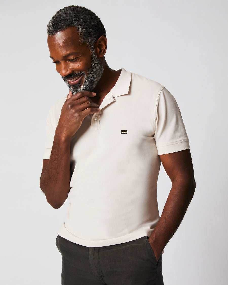 Male model wears the Pique Polo in Natural