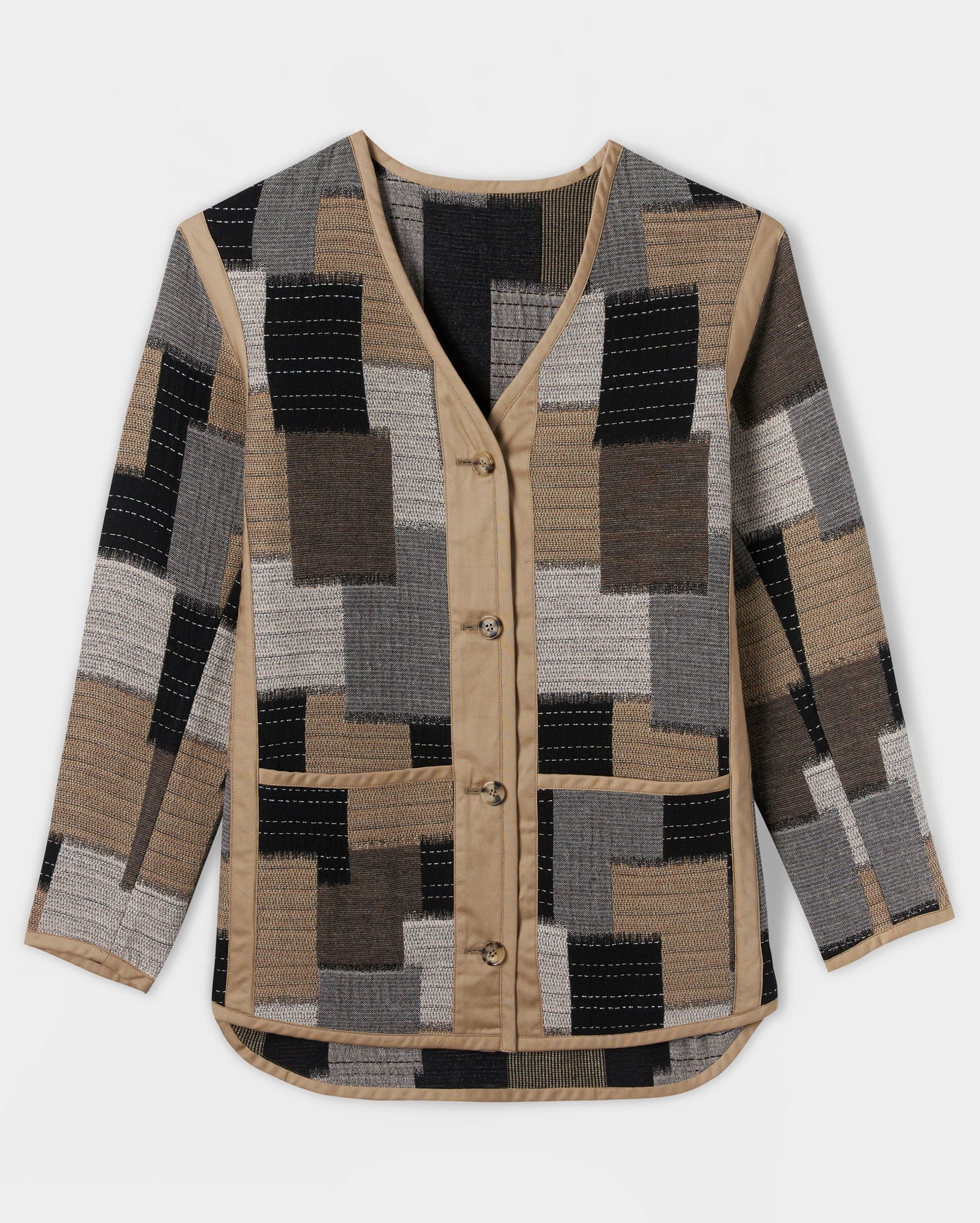 A long-sleeve, button-up cardigan with a V-neck and a patchwork pattern in beige, grey, black, and brown tones. The cardigan features contrasting beige trim along the front, collar, and hem.