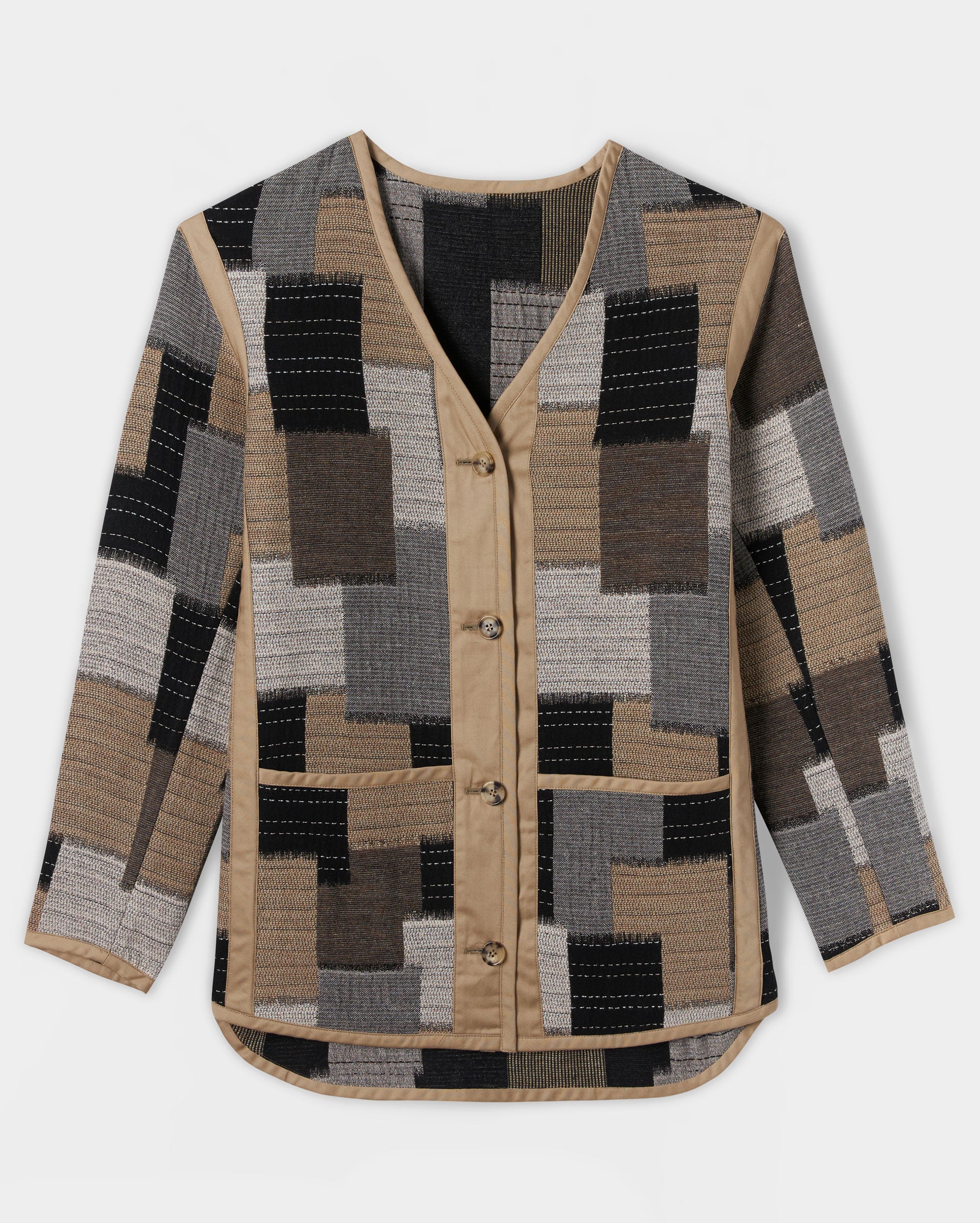 A long-sleeve, button-up cardigan with a V-neck and a patchwork pattern in beige, grey, black, and brown tones. The cardigan features contrasting beige trim along the front, collar, and hem.