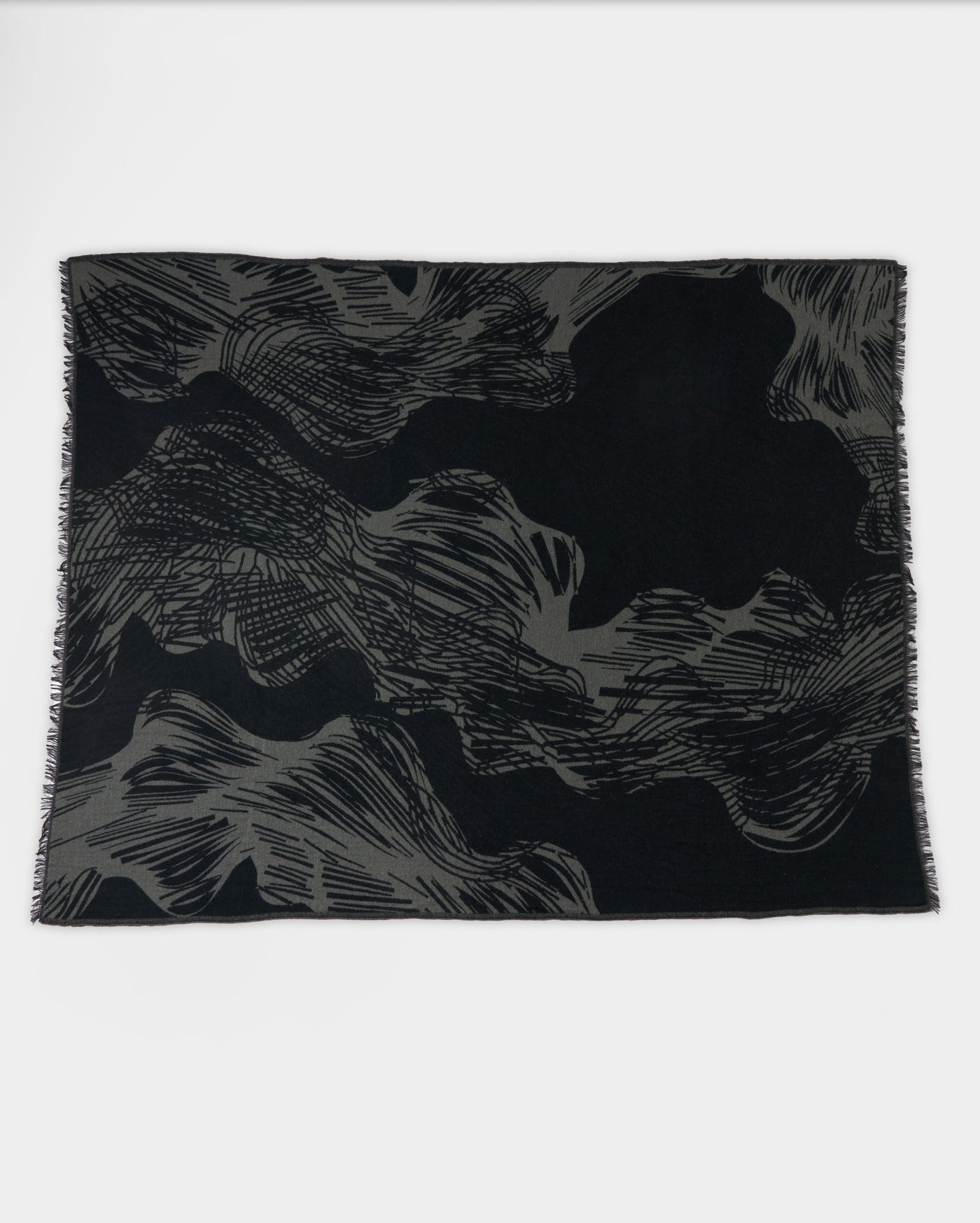 A rectangular black scarf with abstract gray wavy and linear patterns, laid flat on a white background.