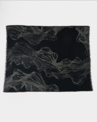 A rectangular black scarf with abstract gray wavy and linear patterns, laid flat on a white background.
