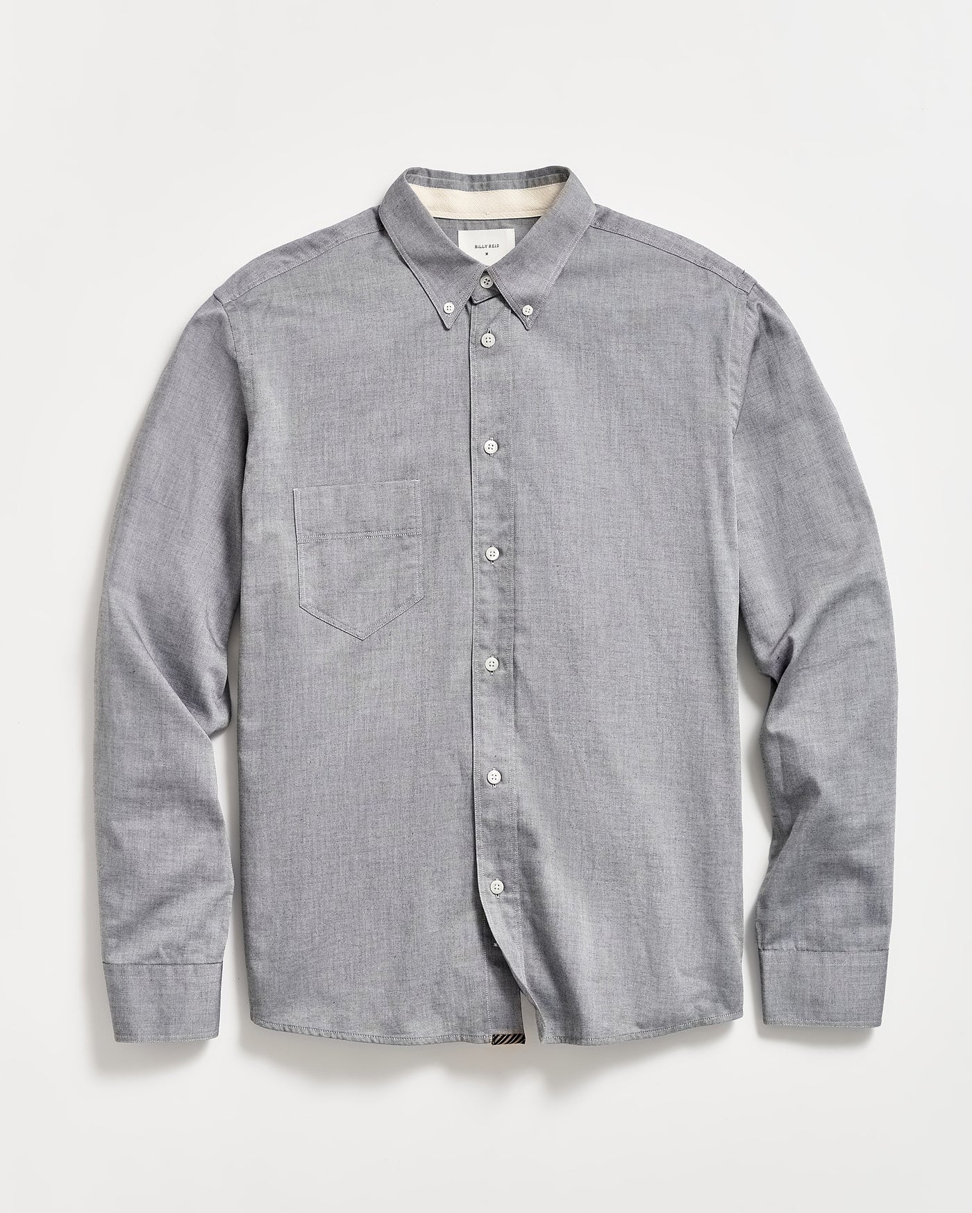 A light gray, long-sleeve button-down shirt with a single chest pocket, buttoned collar, and white buttons, laid flat on a white background.