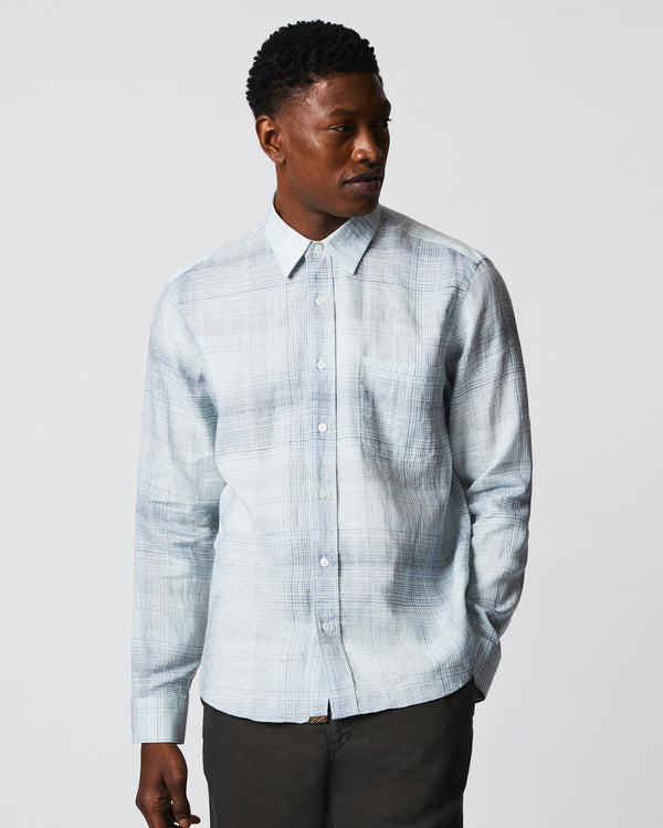 Male model wears the Tuscumbia Shirt in Limestone/Slate plaid