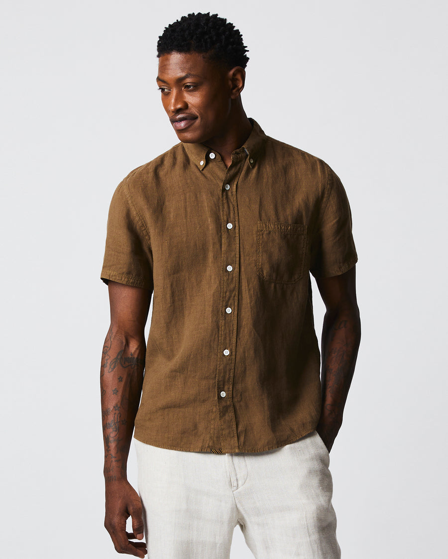 Male model wears the Short Sleeve Linen Tuscumbia Shirt Button Down in Military
