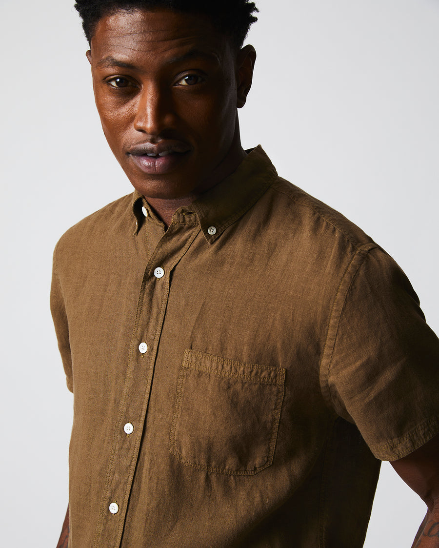 Male model wears the Short Sleeve Linen Tuscumbia Shirt Button Down in Military