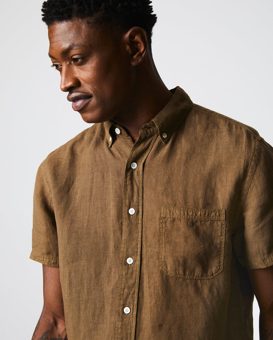 Male model wears the Short Sleeve Linen Tuscumbia Shirt Button Down in Military