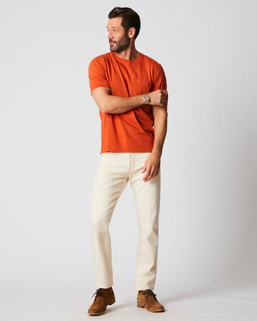 Male model wears the washed tee in burnt red with chino pant.
