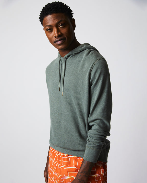 Male model wears the Thermal Hoodie in Slate Green