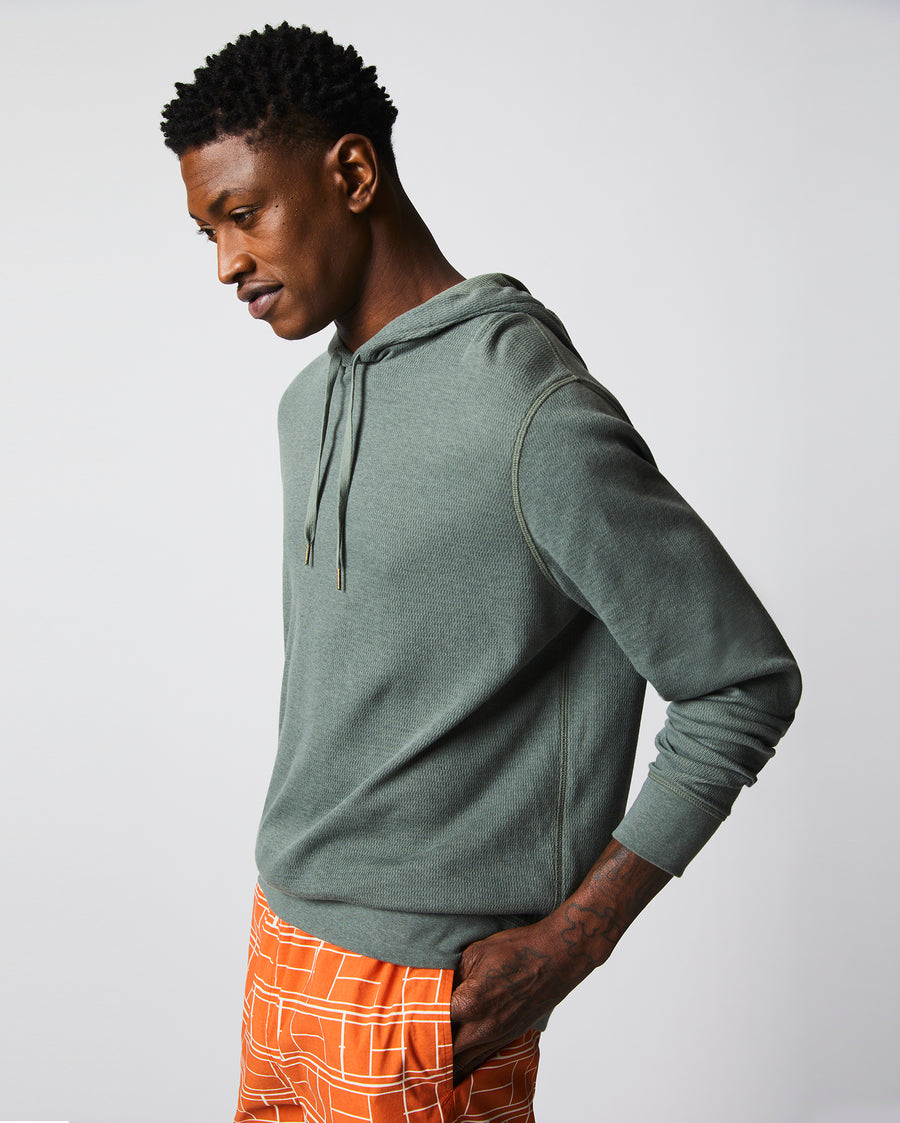 Male model wears the Thermal Hoodie in Slate Green