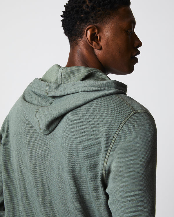 Male model wears the Thermal Hoodie in Slate Green