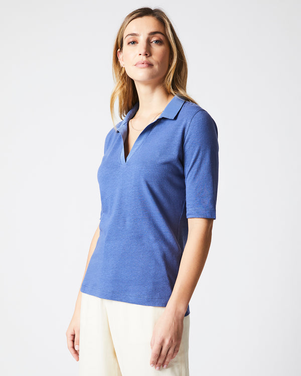 Female model wears the polo knit in Coastal Blue