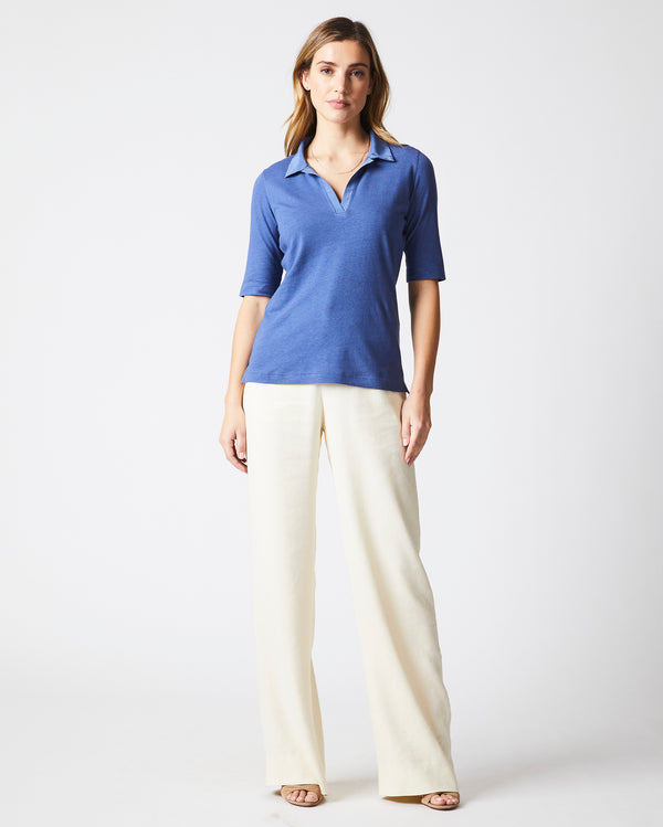 Female model wears the polo knit in Coastal Blue