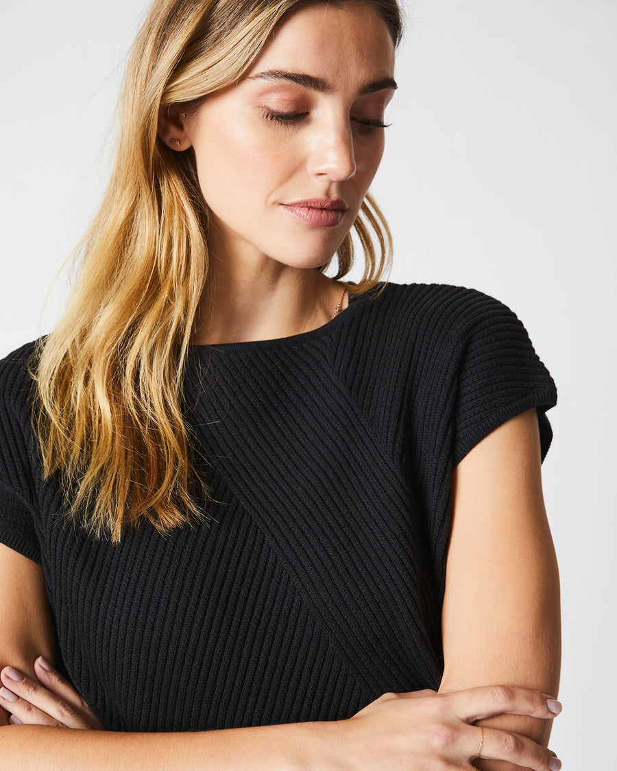 Female model wears the Transfer Rib Sweater in Black