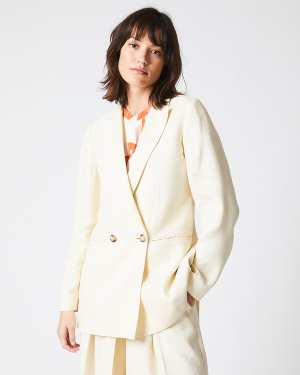 Female Model wears the Jeanne Jacket in Tinted White