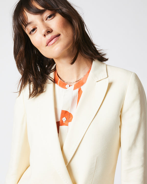 Female Model wears the Jeanne Jacket in Tinted White
