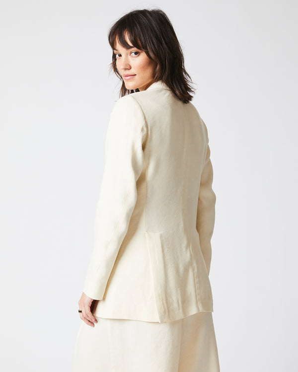 Female Model wears the Jeanne Jacket in Tinted White