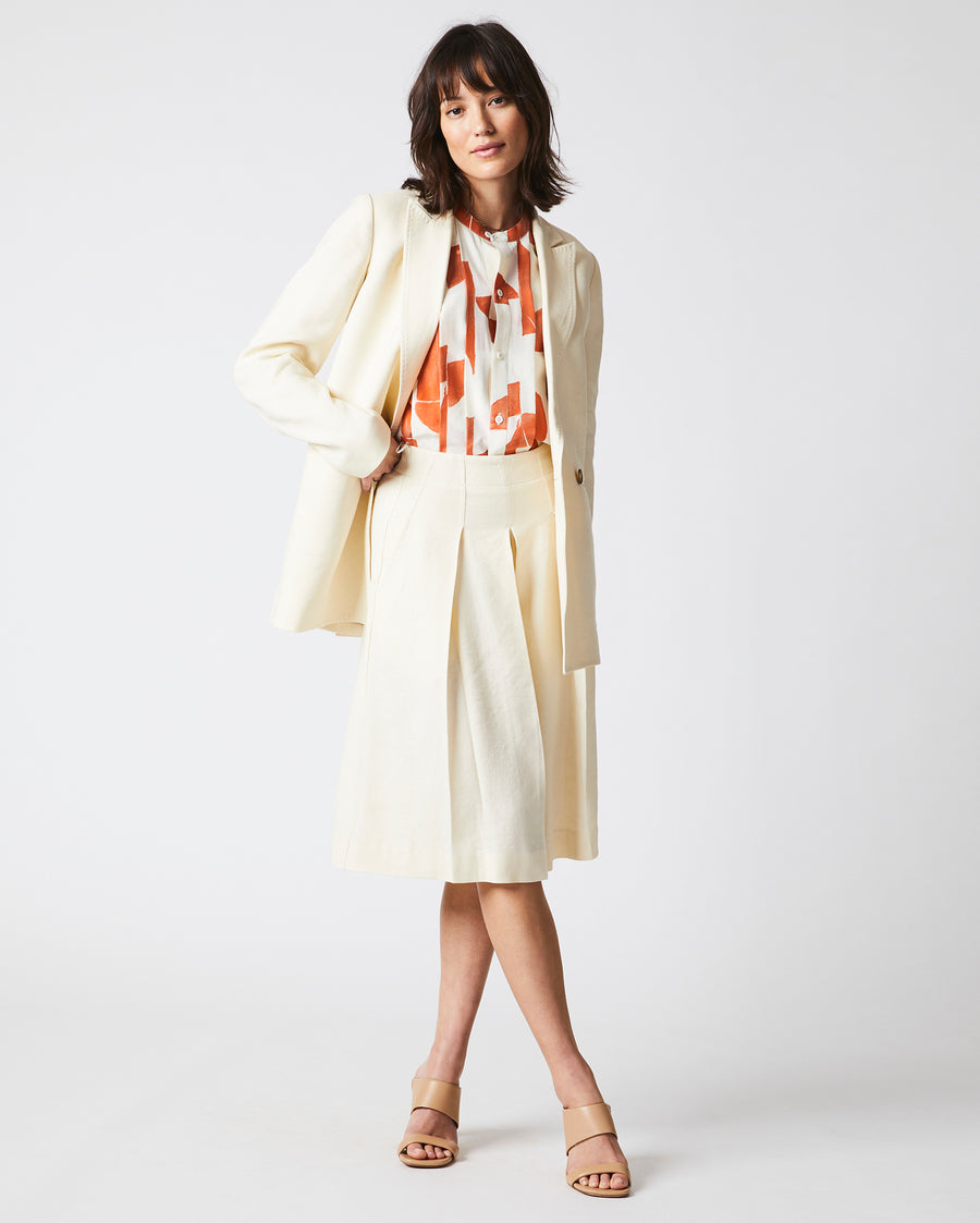 Female Model wears the Jeanne Jacket in Tinted White