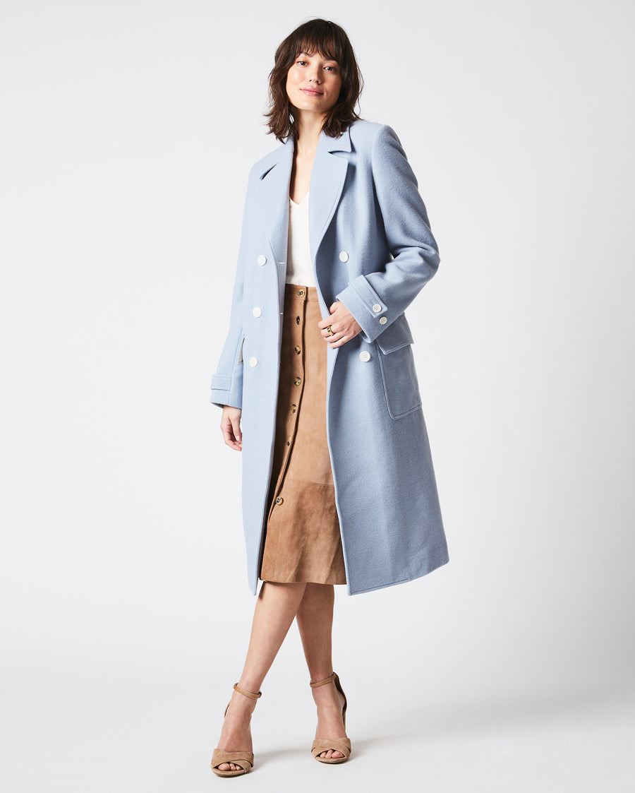 Female model wears the Macdougal Coat in Light Blue