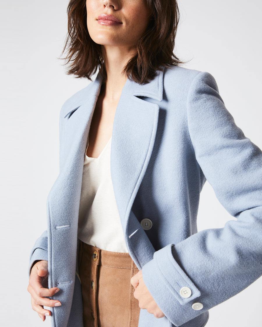 Female model wears the Macdougal Coat in Light Blue