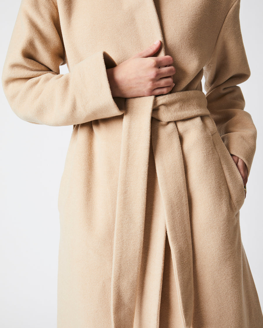 Female model wears the Camille Wrap Coat in Camel