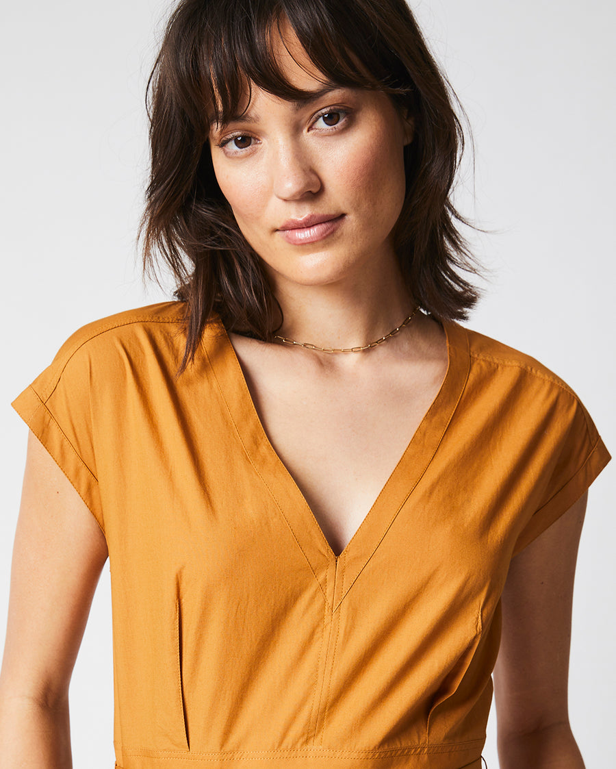 Female model wears the V Neck Dress in Caramel